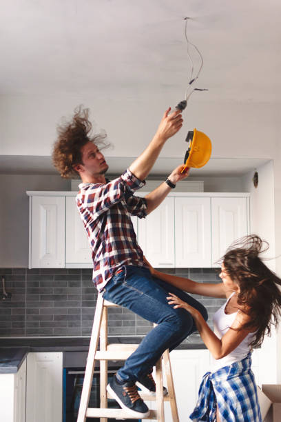istock Man Changing Light bulb in new home 1044085008