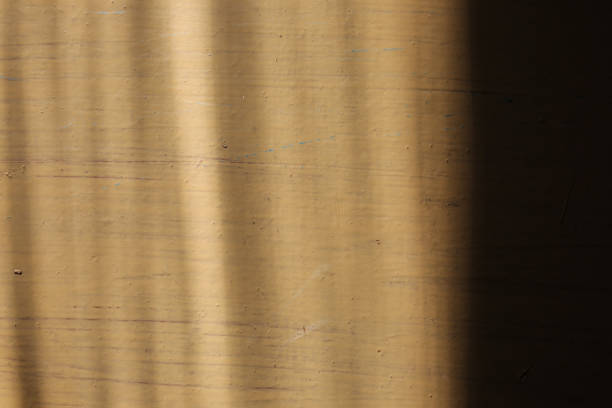 istock Beige painted background with sun lights on it. Whitewash texture. 1044095450