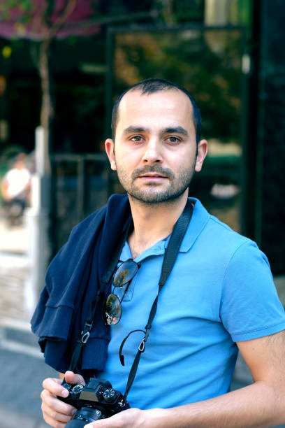 istock Tourist man is holding a camera 1044100284