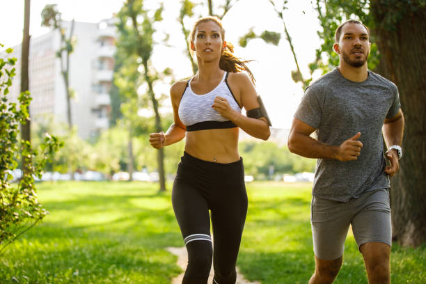 istock Couple is running in park 1044100522