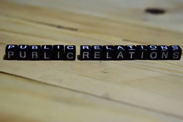 Photo of Public relations message written on wooden blocks.