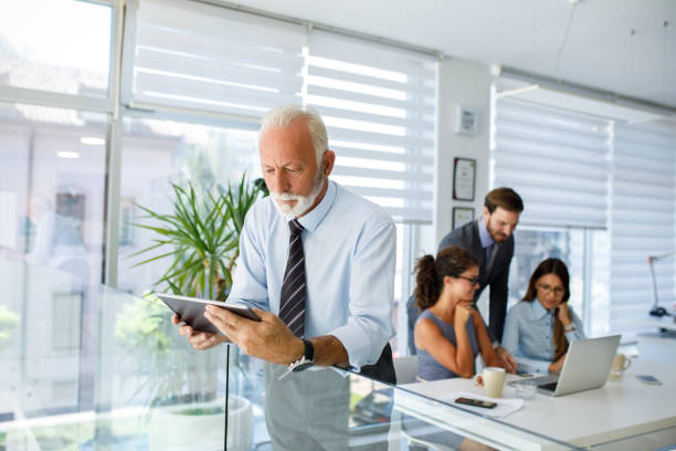 istock Senior businessman using digital tablet in the office 1044107450