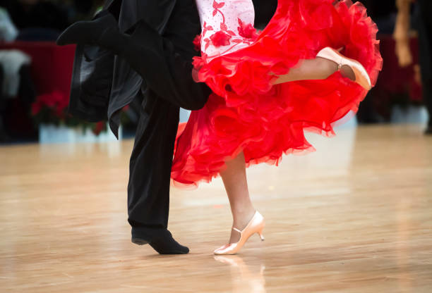 istock Low Section Of Couple Dancing On Hardwood Floor 1044108572