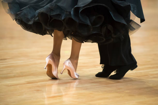 istock Low Section Of Couple Dancing On Hardwood Floor 1044108596