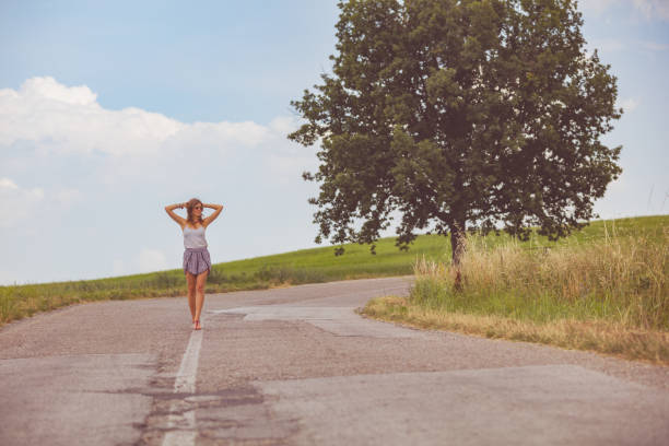 Girl walking on a empty suburb road.