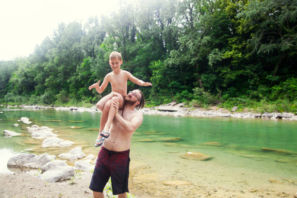 istock Father and son at the river 1044109346