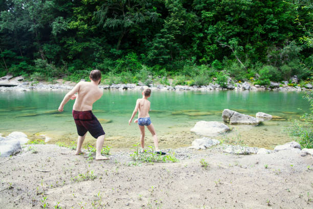 istock Father and son at the river 1044109360