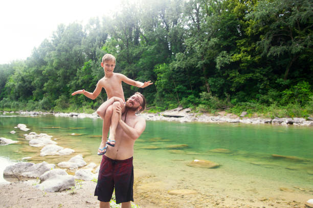 istock Father and son at the river 1044109374