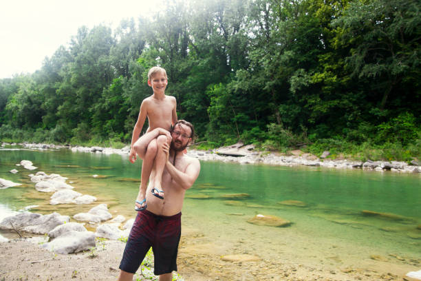 istock Father and son at the river 1044109376