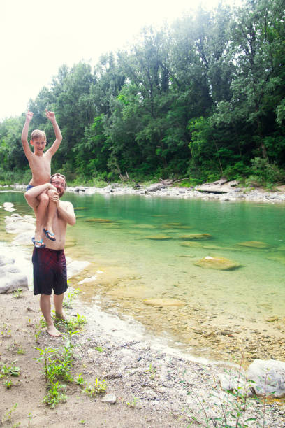 istock Father and son at the river 1044109390