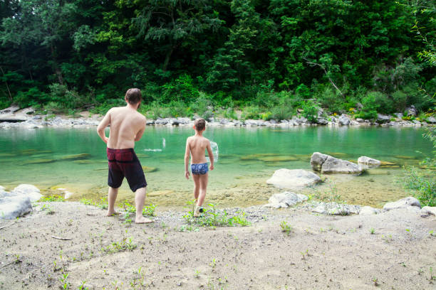 istock Father and son at the river 1044109526