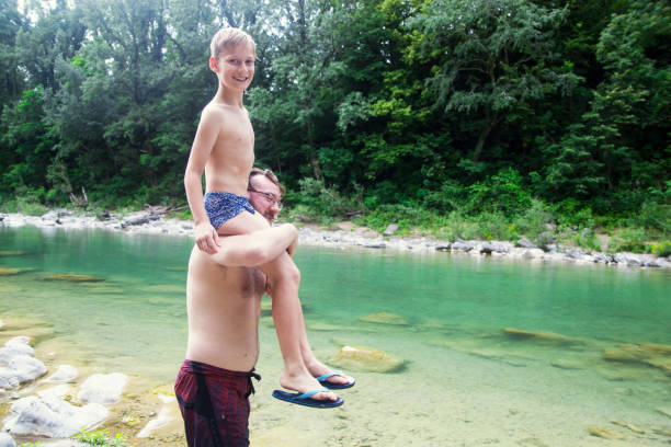 istock Father and son at the river 1044109662