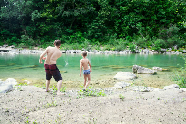 istock Father and son at the river 1044109730