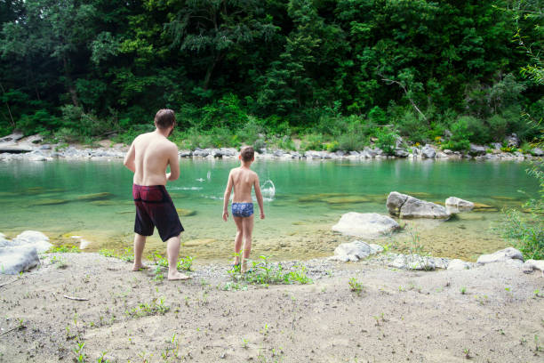 istock Father and son at the river 1044109742