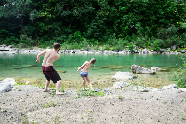istock Father and son at the river 1044110040