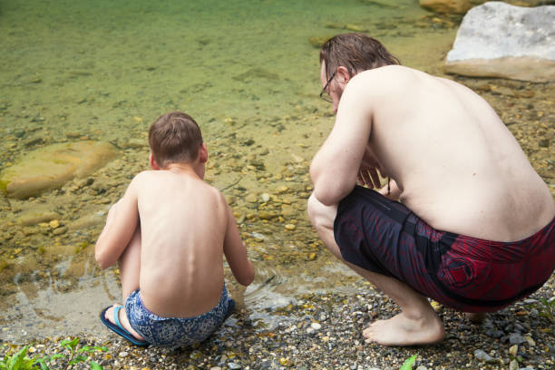 istock Father and son at the river 1044110610