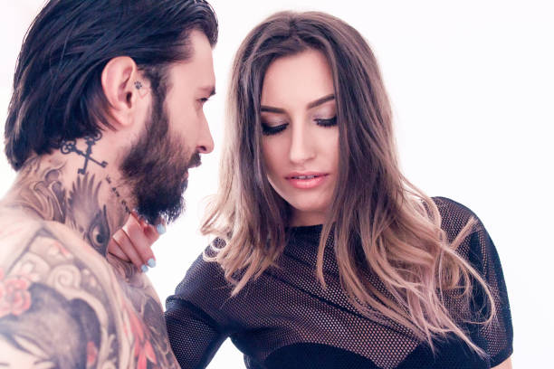 istock Sensual young woman touching a tattooed man 1044111056
