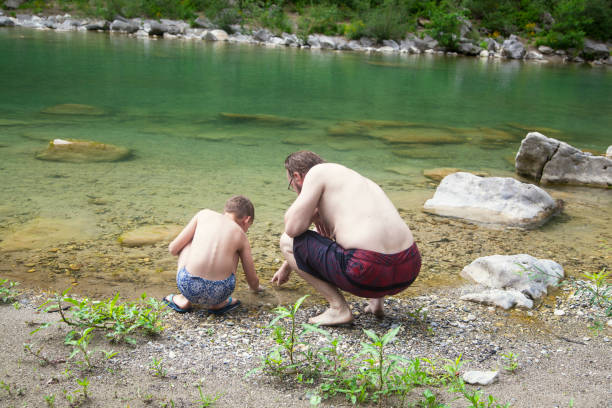 istock Father and son at the river 1044112658