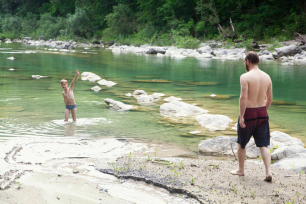 istock Father and son at the river 1044112678