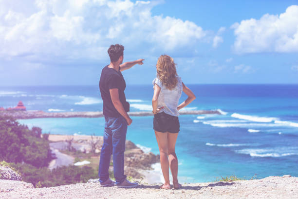 istock Couple looking at a tropical ocean / sea scenery. 1044114774