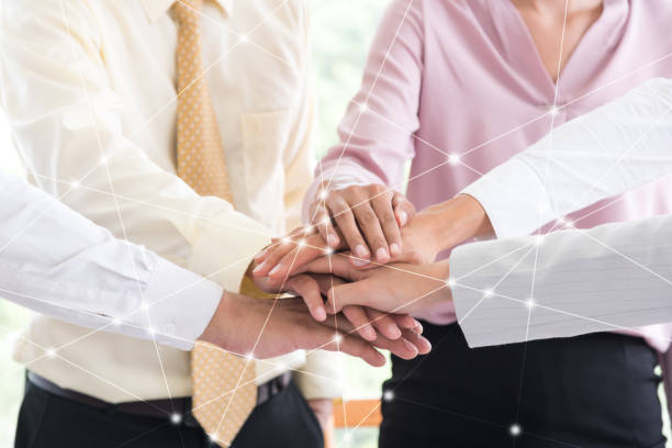 istock Digital Composite Image Of Colleagues Stacking Hands At Office 1044114860