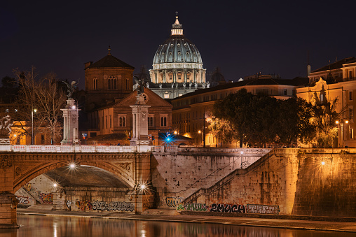 Rome, dome of St. Peter's Basilica at night, seen from the Tiber river