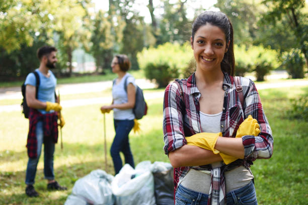 istock Young volunteers collect garbage in a public park 1044116028