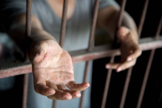 istock Midsection Of Woman Standing In Prisoner 1044119270