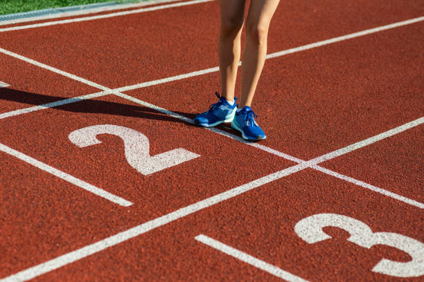 istock Female legs on start point at running track 1044120194