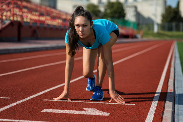 istock Female runner on starting point in stadium 1044120448