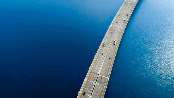 Aerial view of a high way over blue water Aerial view of a high way road on the bridge over blue water sea bridge stock pictures, royalty-free photos & images