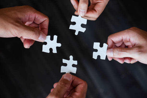 istock Cropped Image Of Hands Holding Jigsaw Pieces 1044123738
