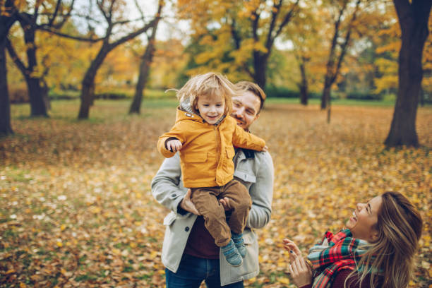 istock Happy parents having fun with their small son in autumn day. 1044140038