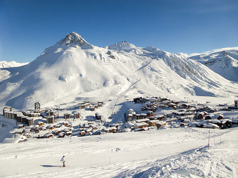 Ski resort of Tignes in winter, ski slope and village of Tignes le lac in the background
