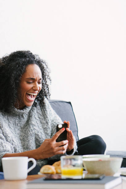 istock Young beautiful woman using smartphone on sofa 1044141226