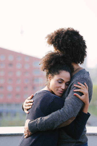 istock Young couple on a rooftop terrace at sunset 1044141856