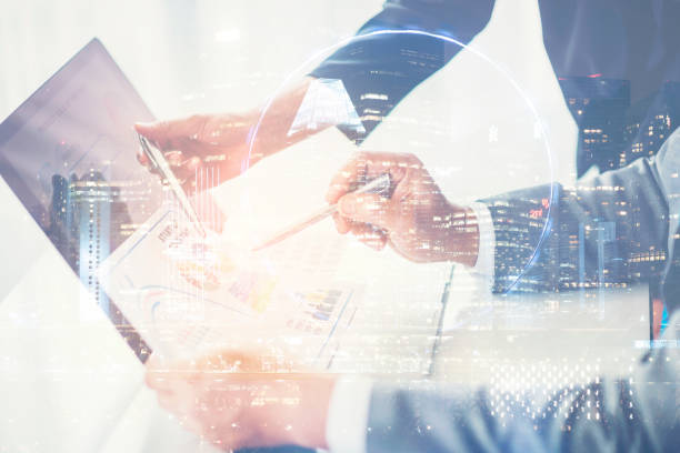 istock Double Exposure, Image of two young businessmen using touchpad at meeting 1044145164