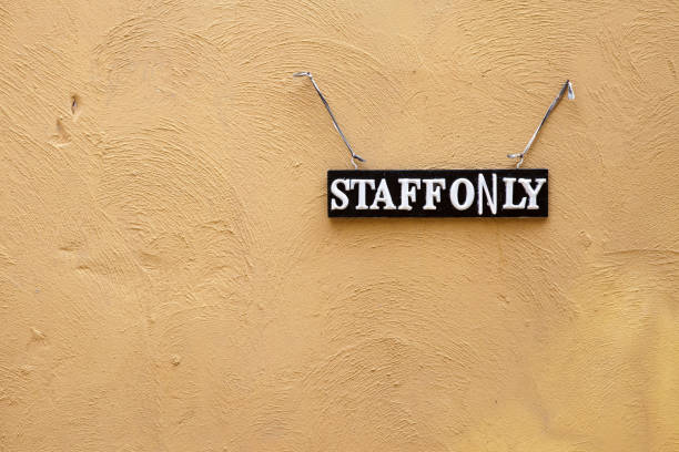 istock Staff only sign hanging on concrete wall 1044145622