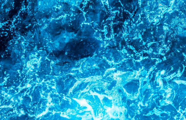 istock Blue sea foaming water background 1044153216