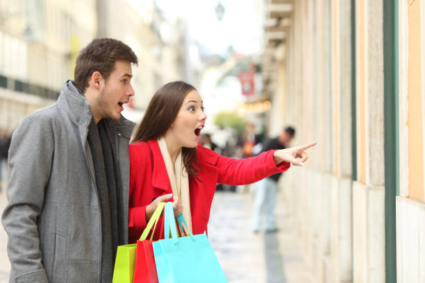 istock Amazed shoppers finding sales in a storefront 1044153322