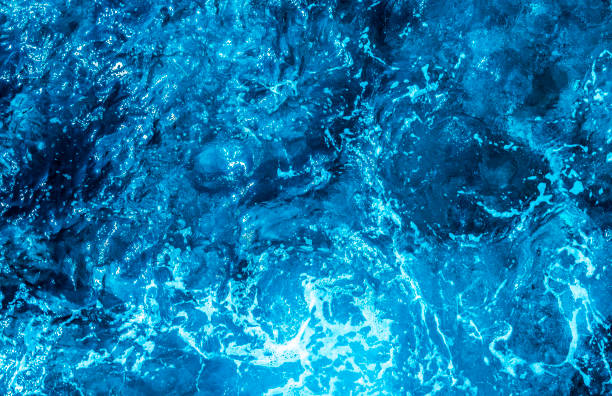 istock Blue sea foaming water background 1044153390