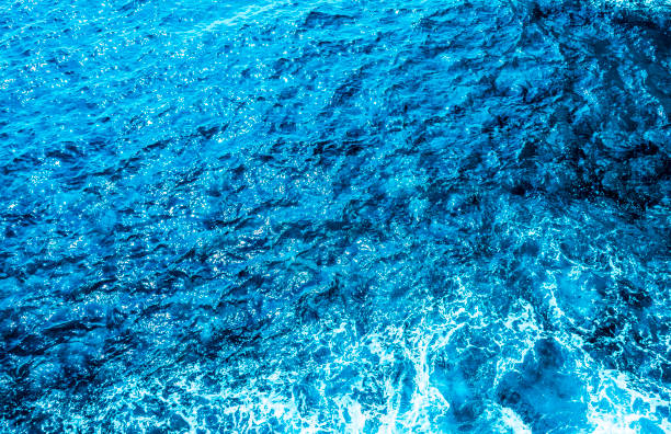 istock Blue sea foaming water background 1044153558