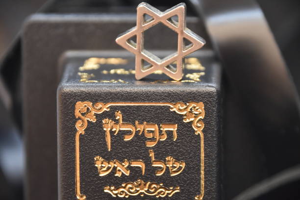 Entrance on Jewish cemetery. Jewish David star symbol with hebrew inscription.