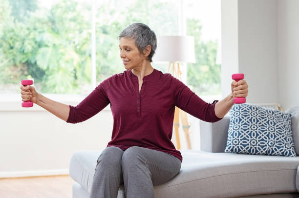 istock Old woman exercising with dumbbells 1044153994