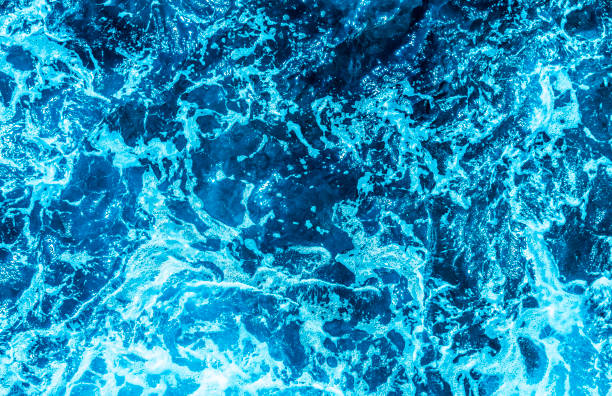 istock Blue sea foaming water background 1044154450