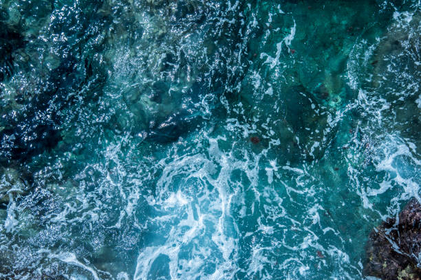 istock Blue sea foaming water background 1044154848
