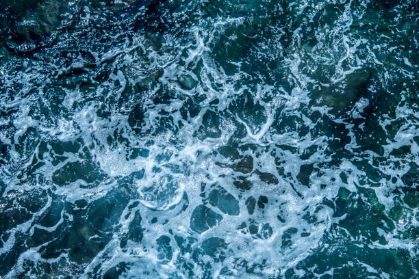 istock Blue sea foaming water background 1044157098