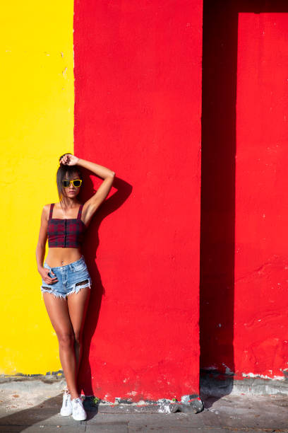 istock Beautiful woman standing in front of colored background 1044157702