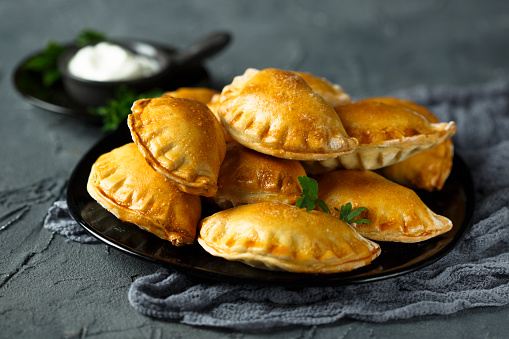 Homemade savory hand pies with potato, Feta cheese and garlic