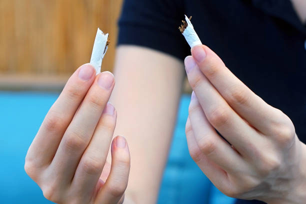 istock A girl breaks a cigarette. Quit smoking. 1044162686